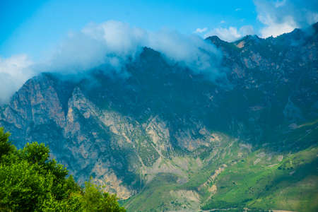 The peaks of blue-green mountains against the sky,the summer.The Caucasus..Russia.