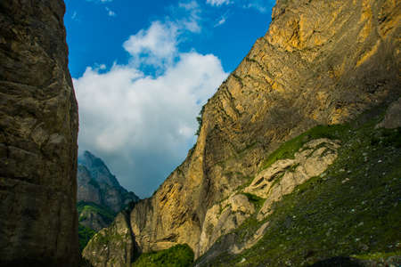 Beautiful mountains in the clouds on the blue sky background,the summer.The Caucasus..Russia.の写真素材