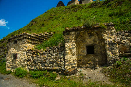 City of the dead.Stone ancestral tombs on the hill with mountains in the background, inside the bone. The Caucasus.Russia.の写真素材
