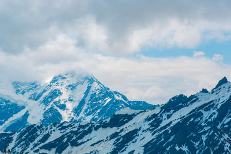 Beautiful mountains in the white snow against the blue sky in the clouds.Winter.The Elbrus...