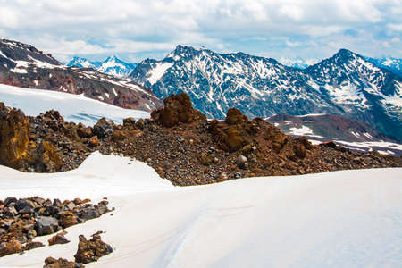 Beautiful mountains in the white snow against the blue sky in the clouds.Winter.The Elbrus region.The Caucasus.Russia.の写真素材