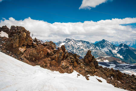 Beautiful mountains in the white snow against the blue sky in the clouds.Winter.The Elbrus region.The Caucasus.Russia.の写真素材