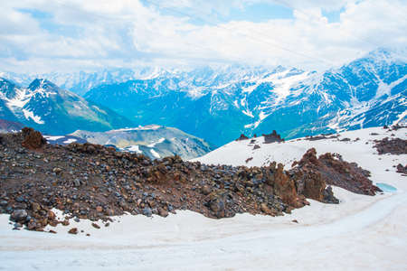 Beautiful mountains in the white snow against the blue sky in the clouds.Winter.The Elbrus region.The Caucasus.Russia.の写真素材