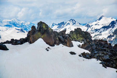Beautiful mountains in the white snow against the blue sky in the clouds.Winter.The Elbrus region.The Caucasus.Russia.の写真素材