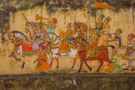 Traditional ancient stile indian wall painting on the old plastered wall in Udaipur, Rajasthan, Indiaの写真素材