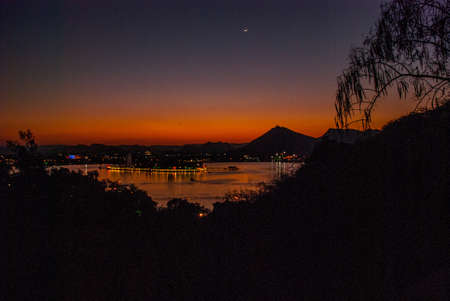 Beautiful view of the city. A month on sky. House, mountains on the horizon. Panorama city Udaipur, Indiaの写真素材