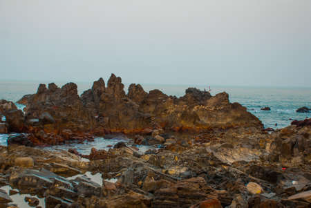 Rocks, stones, sea. Beauty Arambol beach landscape, Goa state, Indiaの写真素材