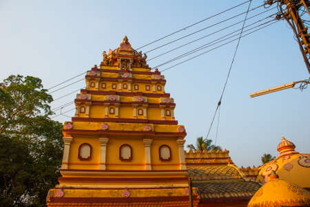 Orange beautiful temple on a background blue sky in Goa. Arambol. India.の写真素材