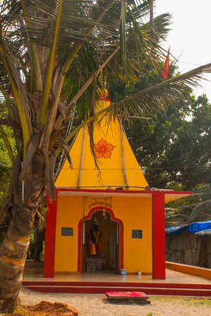 Beautiful red and yellow small temple on the beach. Goa. Arambol. India.の写真素材