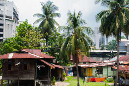 Street with houses. Skyscrapers on blue sky background. Road. Kuala Lumpur, Malaysia.の写真素材