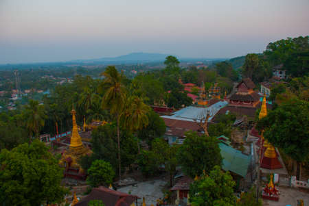 Top view of the city from the pagoda Kyaik Tan Lan. Panorama. Beautiful evening landscape. The Old Moulmein pagoda. Mawlamyine, Myanmar. Burma.の写真素材