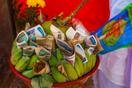 A donation to the temple. Bananas with twisted Burmese money. Myanmar. Burma.の写真素材