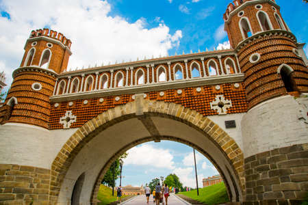 The architecture of the Tsaritsyno Park in Moscow in the summer. Old brick arch bridge. Russia. A popular tourist attraction.の写真素材