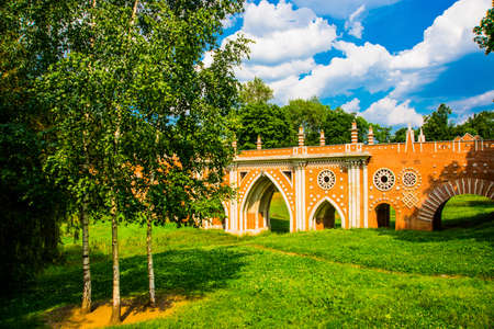 The architecture of the Tsaritsyno Park in Moscow in the summer. Old brick arch bridge. Russia. A popular tourist attraction.の写真素材