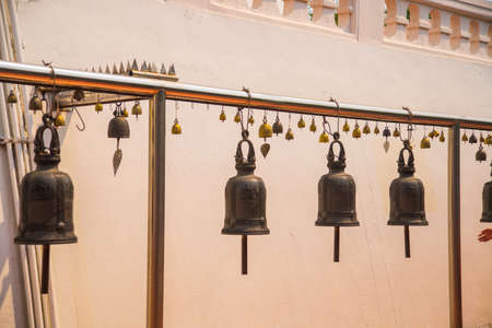 The bells on the white background of the wall of the temple.Thailand. Bangkok.