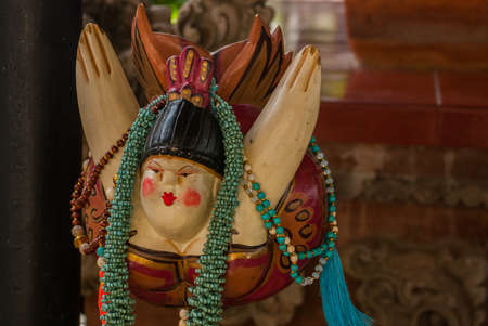 Balinese market. Souvenirs of wood and crafts of local residents. Colorful Souvenirs and figurines. Bali, Indonesia. Souvenir a female bird.の写真素材