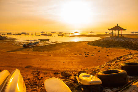 Traditional Balinese ships Jukung in Sanur beach at sunrise, Bali, Indonesiaの写真素材