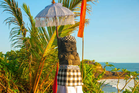 Tanah Lot water temple in Bali. Indonesia.Traditional sculpture from the stone demon.の写真素材