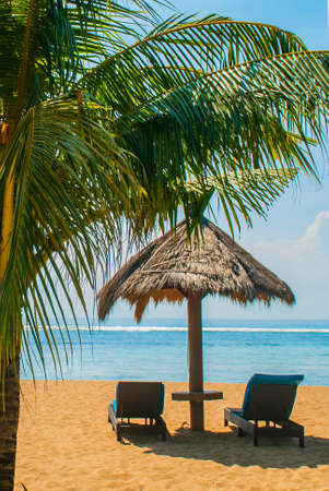 Benoa sand beach view. Bali, Indonesia, Tanjung Benoa. Nusa Dua. Sun loungers and parasols on the beach.の写真素材