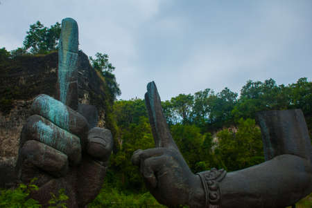 Huge beautiful hands of a statue of Vishnu. Detail of the sculpture.Garuda Wisnu Kencana Cultural Park. Bali. Indonesia. GWK.の写真素材