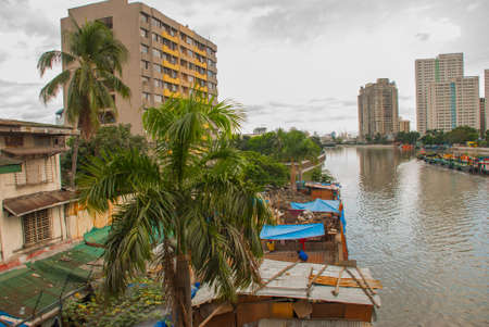 The view from the bridge over the river and skyscrapers in the capital Manila, Philippinesの写真素材