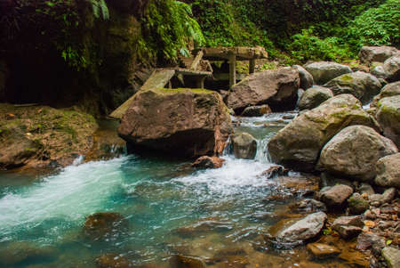 The huge stones near the waterfall Casaroro in the national Park. Philippines. Valencia, island Negros.の写真素材