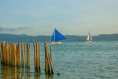 Landscape with sailing boats and mountains in background. Boracay island, Philippinesの写真素材