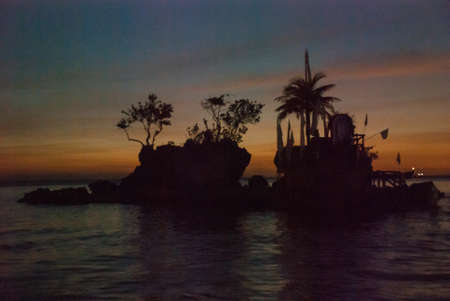 Willys Rock, situated on the famous White Beach, is one of the most recognizable landmarks of Boracay Island, Philippines. Sunsetの写真素材