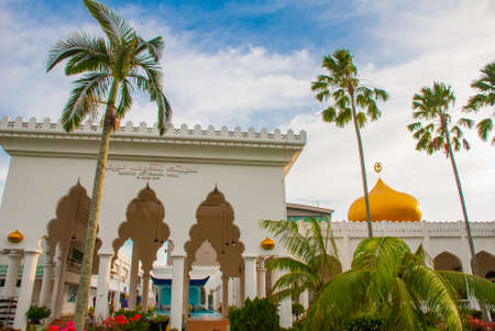 Beautiful Masjid At-Taqwa mosque with its Golden dome and palm trees. Miri city, Borneo, Sarawak Malaysiaの写真素材