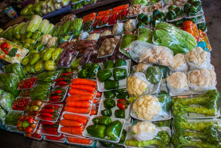 The traditional Asian market with food. Sale a variety of vegetables lying on the counter. Malaysiaの写真素材