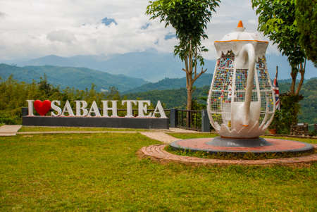 Huge white lettering I love Sabah tea and kettle metal snaps. The mountains on the horizon. Borneo island, Malaysiaの写真素材