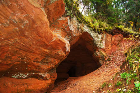 Beautiful Orange cave in Russia. The entrance to the cave. Leningrad oblast.の写真素材