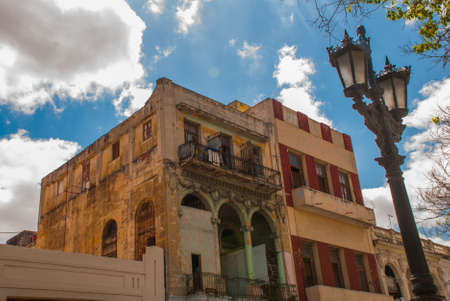 Classic house with arches on blue sky background with clouds, sunny day capital of Cubaの写真素材