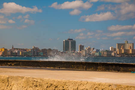 Splashes of waves .View from the Malecon promenade to the city. Cuba. Havana.の写真素材