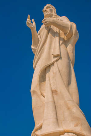 Christ of Havana is a statue by Jilma Madera that overlooks the bay in Havana, Cuba. Seen against a blue sky.の写真素材