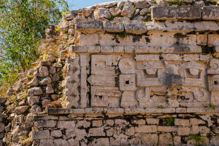 Ancient Mayan drawings on stone. The texture of the stone. Fragment of an old building. Chichen-Itza, Mexico. Yucatan.の写真素材