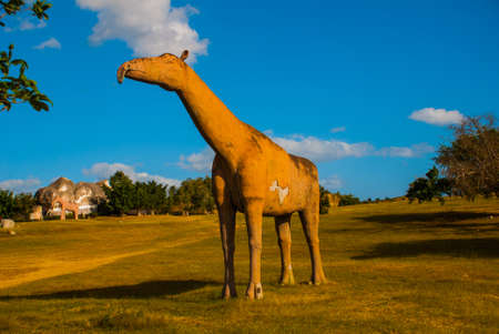 Dinosaur statues on the field. Prehistoric animal models, sculptures in the valley Of the national Park in Baconao, Santiago de Cuba, Cuba.の写真素材
