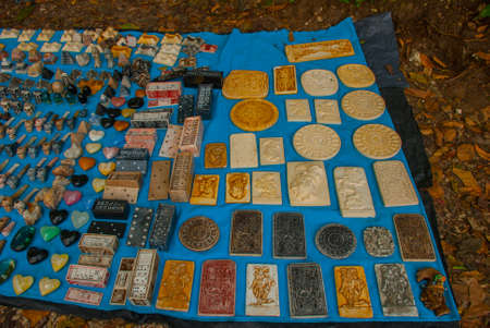 Selling traditional Mexican Souvenirs to tourists on the market. Dominoes, bas-reliefs, pipes...