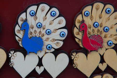 Peacock and hearts. Beautiful handmade Souvenirs made of wood. A traditional Turkish market, Bazaar....