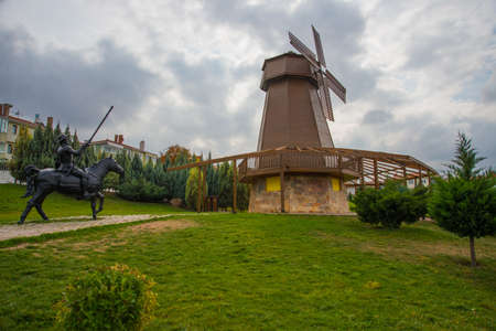 Windmill with sky as background. Sculpture of don Quixote and Sancho Panza. Selale Park, Eskisehir, Turkey. Beautiful landscape in summer in the Park.の写真素材