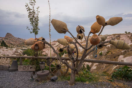 Tree with pots on the hill, in the distance is the city of Uchisar.の写真素材