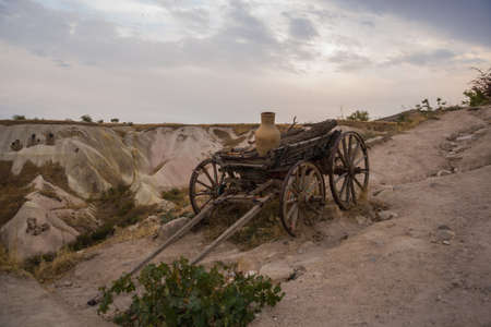 Cart stands on a hill, beautiful landscape with mountainsの写真素材