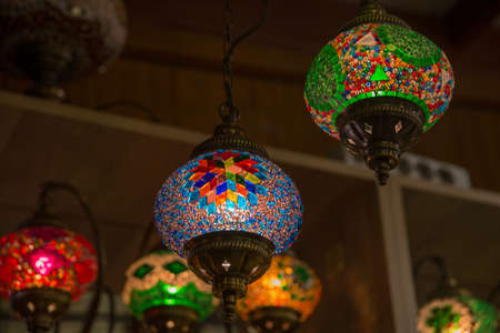 Turkish Bazaar, sale in the market - Souvenirs for tourists. Traditional bright decorative hanging Turkish lights and colourful light lamps with vivid colours in Turkey.の写真素材