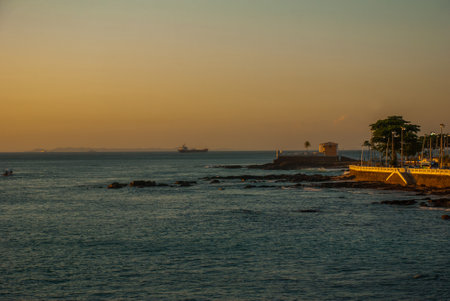 SALVADOR, BAHIA, BRAZIL: Colonial Fort Santa Maria in Barra Salvador Brazil built on tropical beach with palm treesのeditorial素材