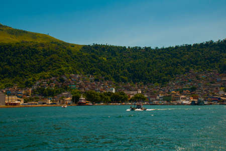 Angra dos Reis, Rio de Janeiro State, Brazil: Santa Luzia Pier in Angra dos Reis. Ships with tourists near the terminal in the portの写真素材