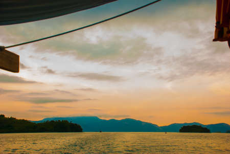 Angra dos Reis, Brazil, Ilha Grande: Beautiful scenery with ships overlooking the sea and mountains at sunset. Brazilian Caribbean.の写真素材