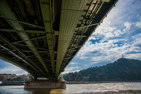 Budapest, Hungary : Liberty bridge over the Danube river in the Hungarian capital Budapest. Liberty Statue or Freedom Statue stands on Gellert Hillの写真素材
