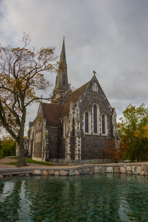 COPENHAGEN, DENMARK: St. Alban's Church, locally often referred to simply as the English Church, is an Anglican church in Copenhagen, Denmark. The steeple reflects on the water.の写真素材