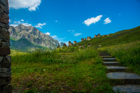 CAUCASUS, NORTH OSSETIA, ALANIA, RUSSIA - JUNE 27, 2015: beautiful view of the stone crypts in the mountains, which are called the city of the deadのeditorial素材