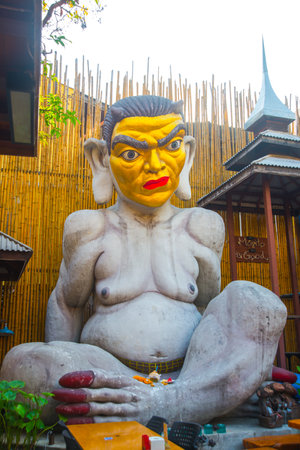 VIENTIANE, LAOS - FEBRUARY 2015: Unusual, and terrible a huge sculpture with a yellow face.
